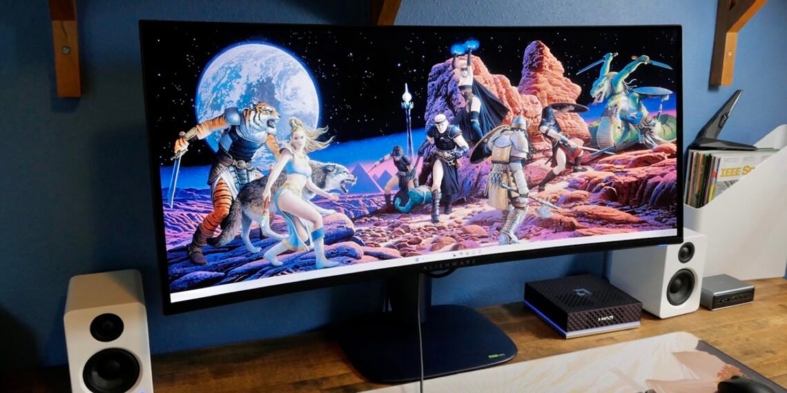 Oyun görüntüsü açık olan Alienware AW3426DW ultrawide monitörlü masa düzeni